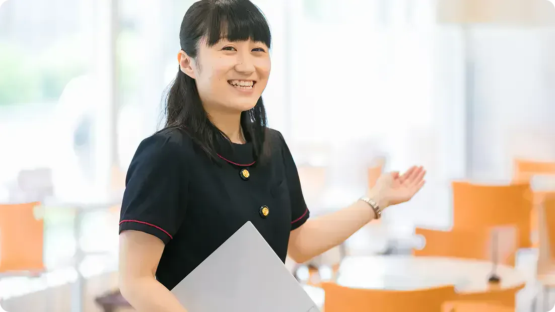 Reception staff showing a student to the lounge