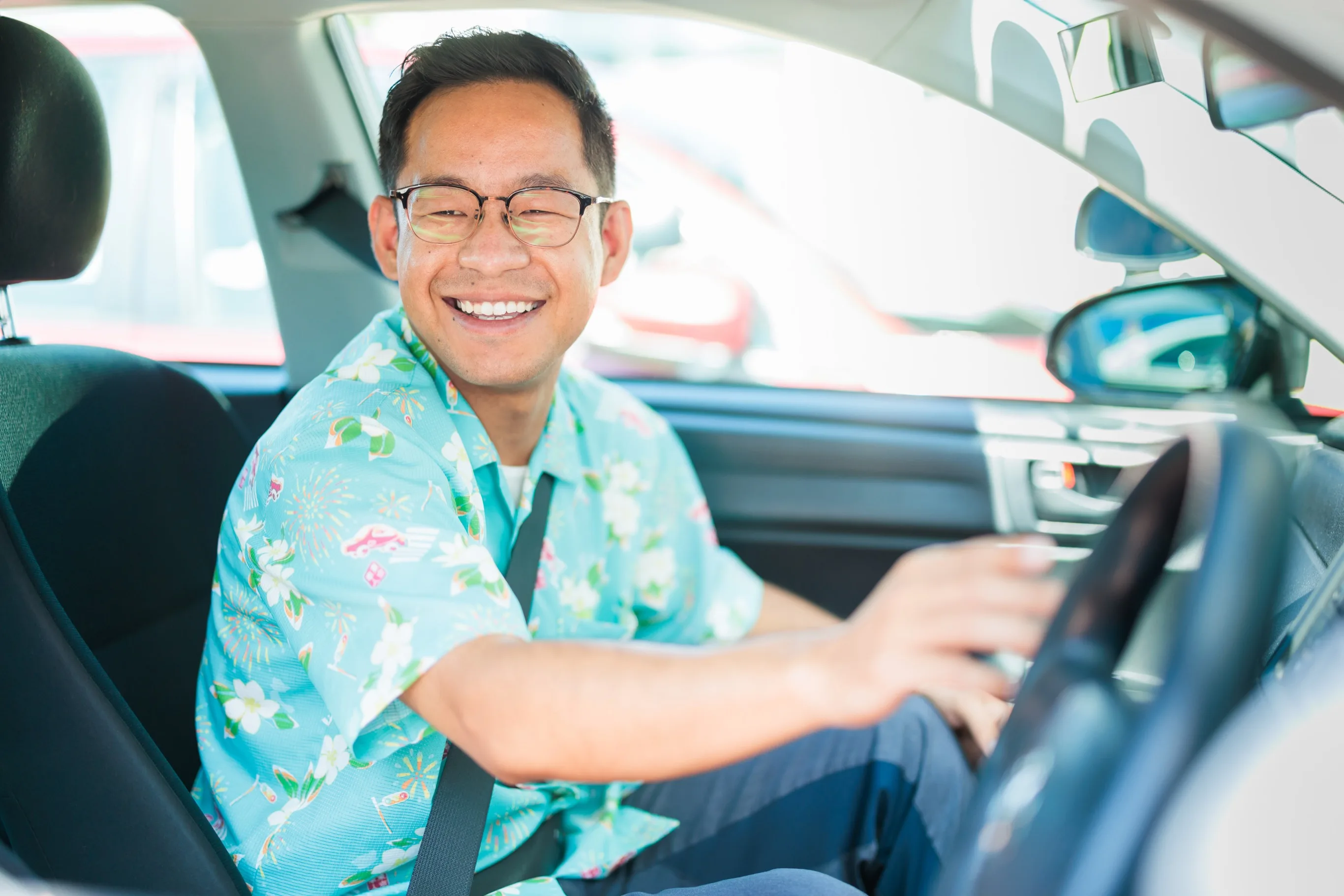Instructor guiding a student behind the wheel