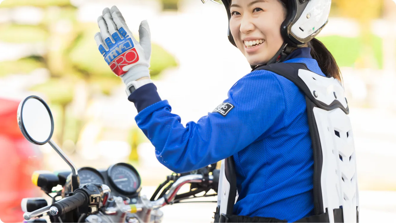 Student rider beside a training motorcycle