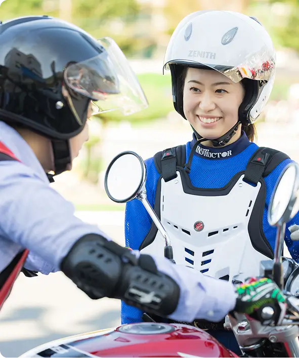 Instructor and student on motorcycles at the school